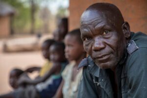 man in green shirt looks at camera