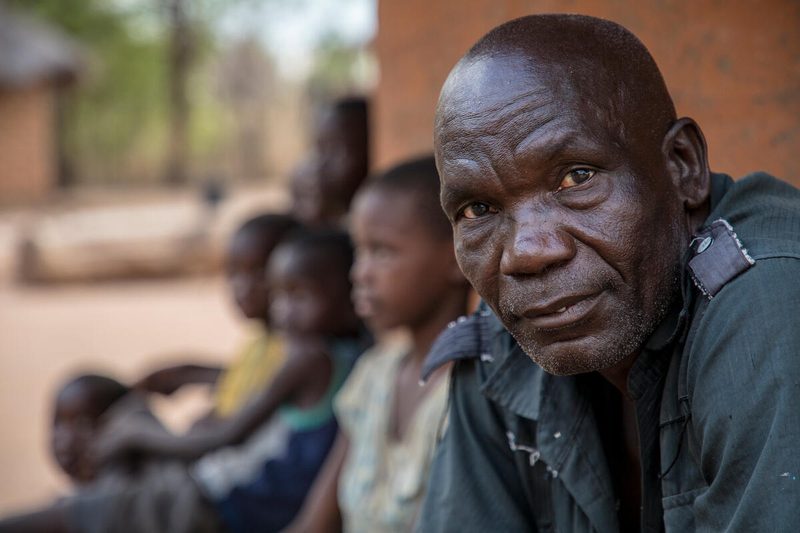 man in green shirt looks at camera