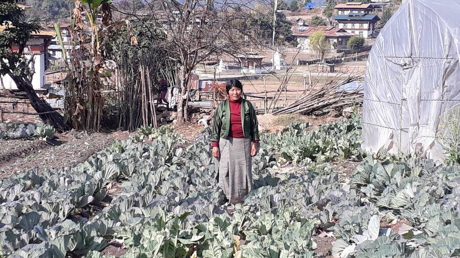 woman standing in field of crops