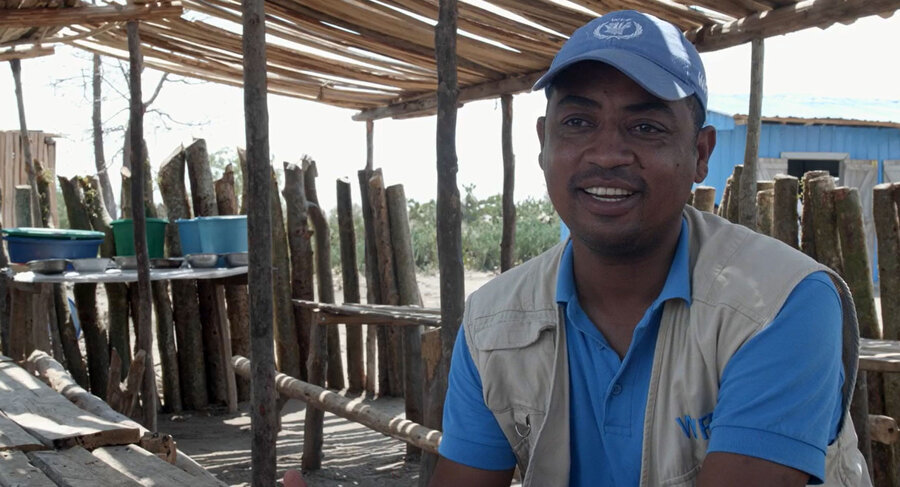 WFP staff in blue shirt and brown vest 