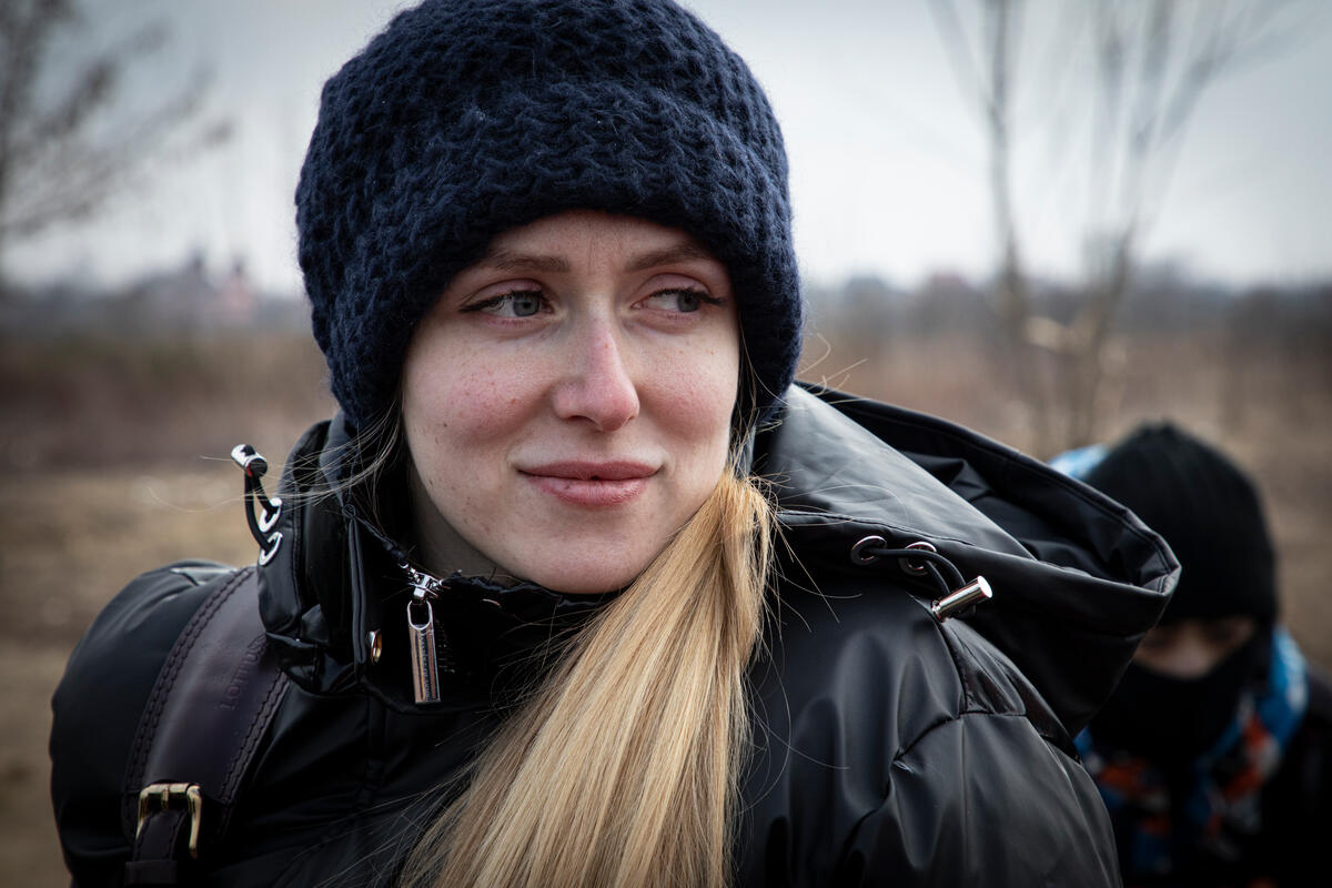 woman with blonde hair in black hat