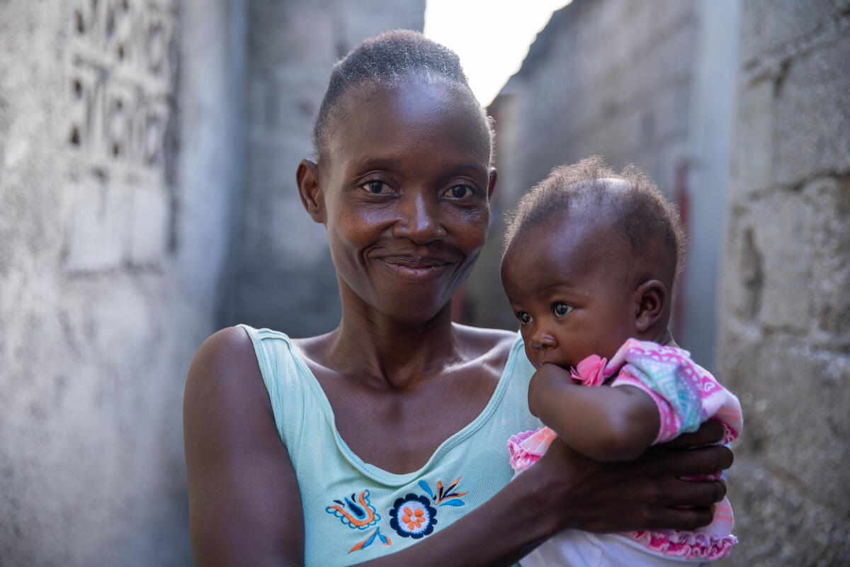 Mother holding her young daughter in Haiti