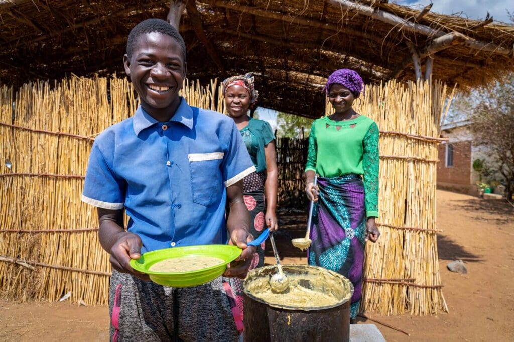 Douglas eats school meals in Malawi