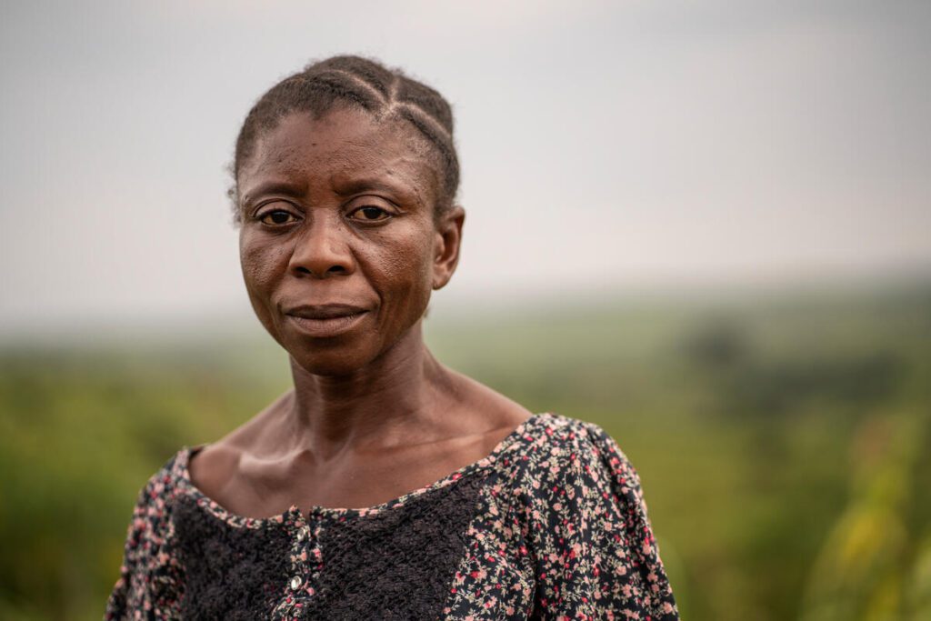 woman in floral shirt in green field