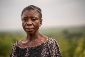 woman in floral shirt in green field