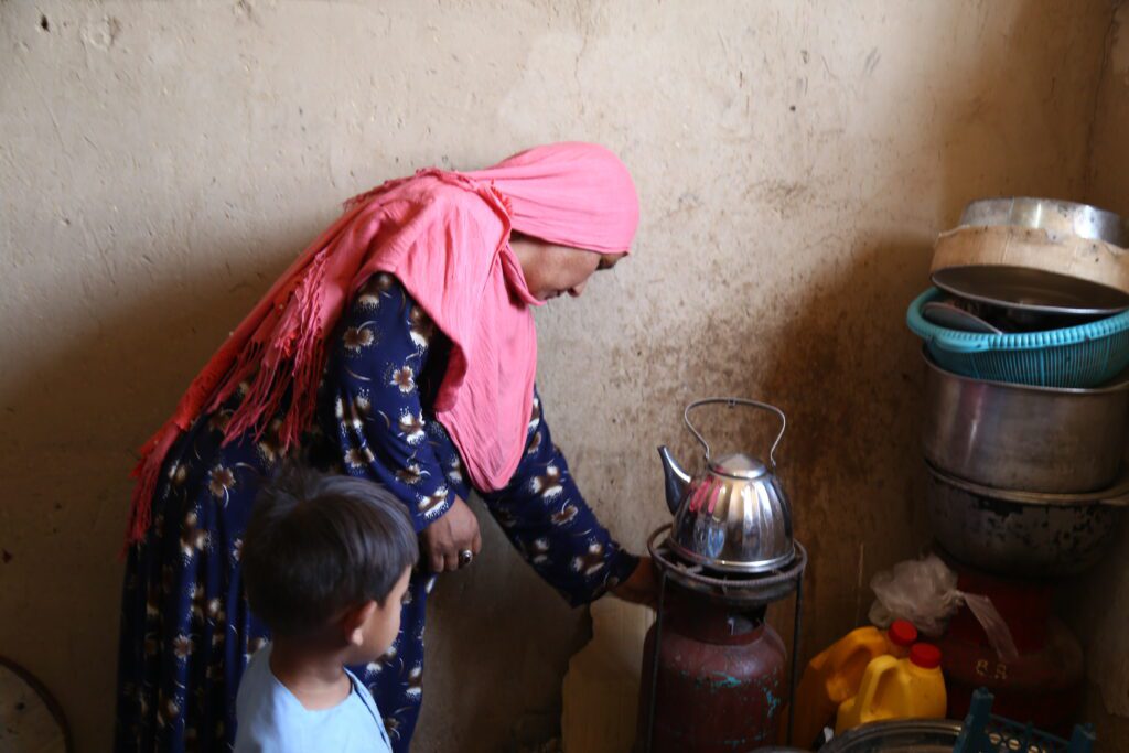woman in pink headscarf cooking