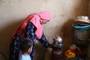 woman in pink headscarf cooking