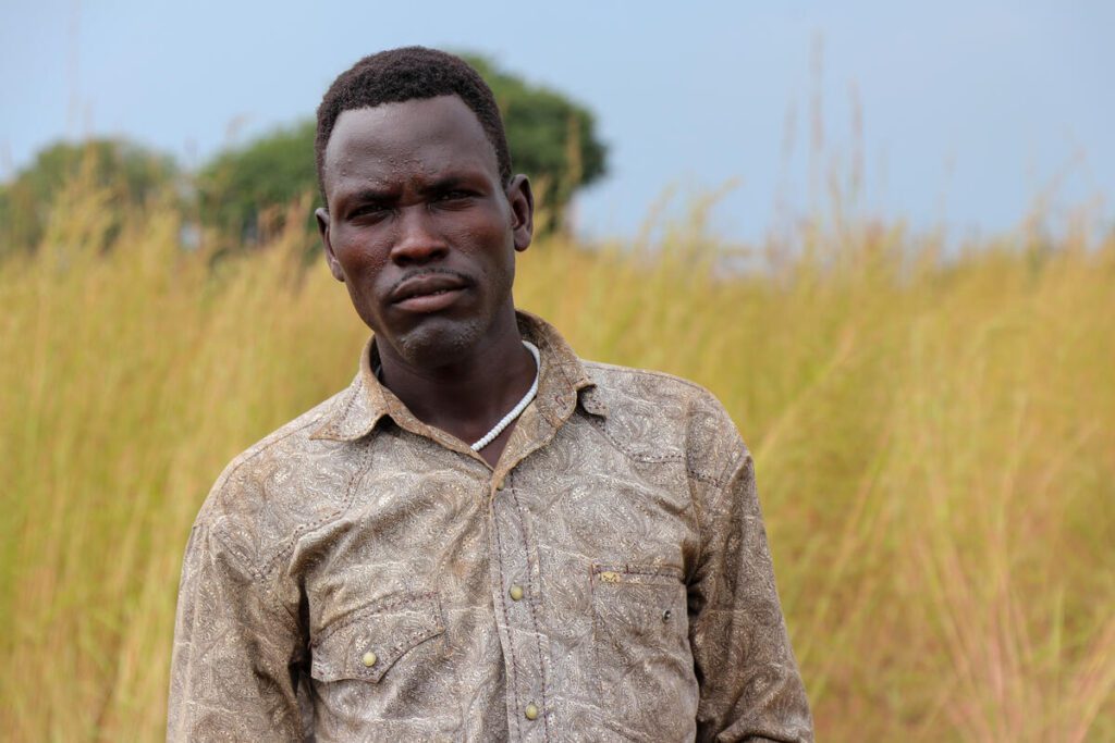 man in khaki shirt in field