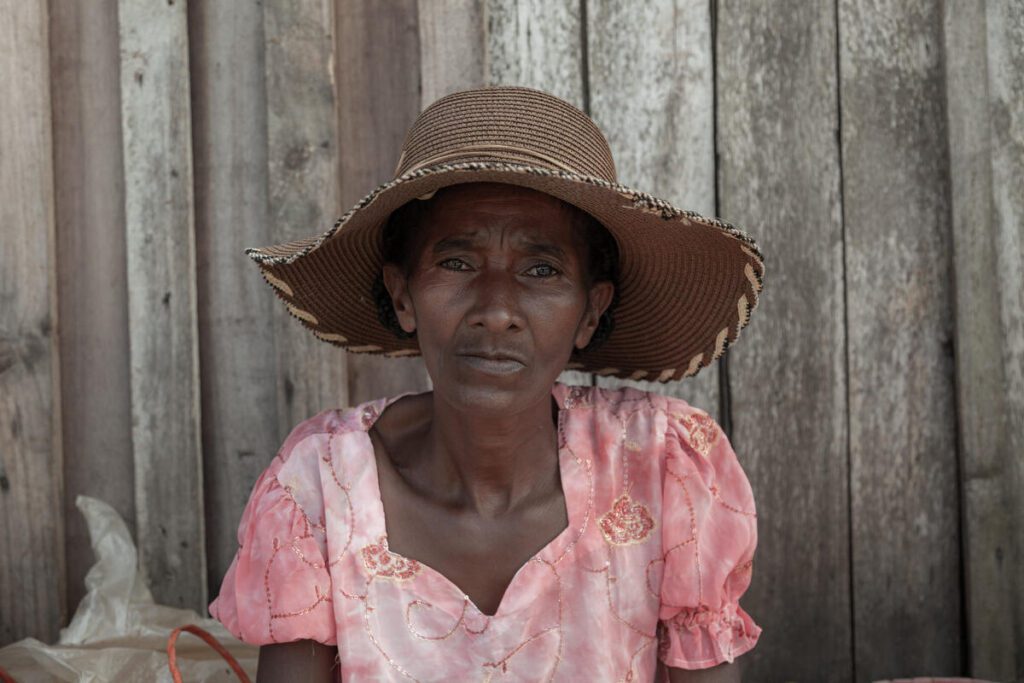 woman in pink shirt and straw sun hat