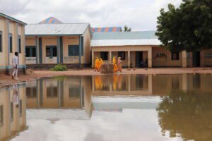 People walk past floodwaters in Somalia