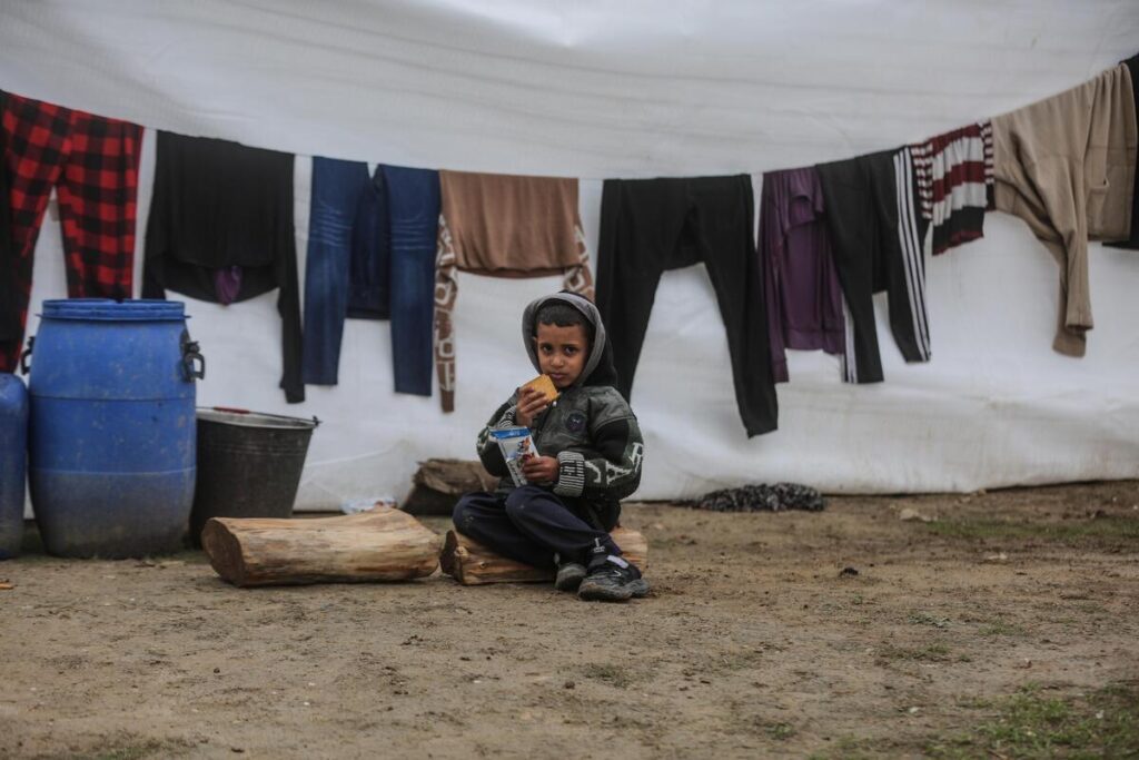 Child eats WFP food ration in Gaza