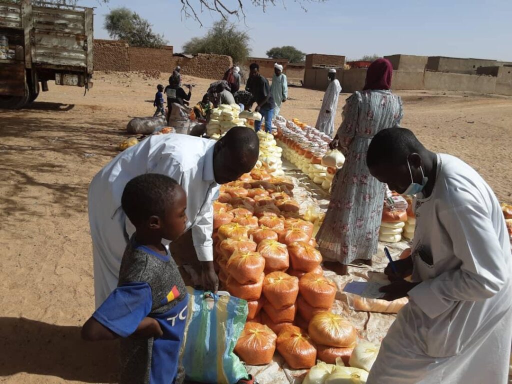 People receive food assistance in Sudan