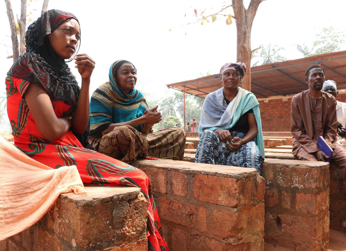People sit on brick benches in a camp for internally displaced people in Bangassou, Central African Republic.