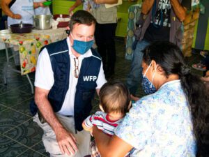 man in WFP vest and covid health mask