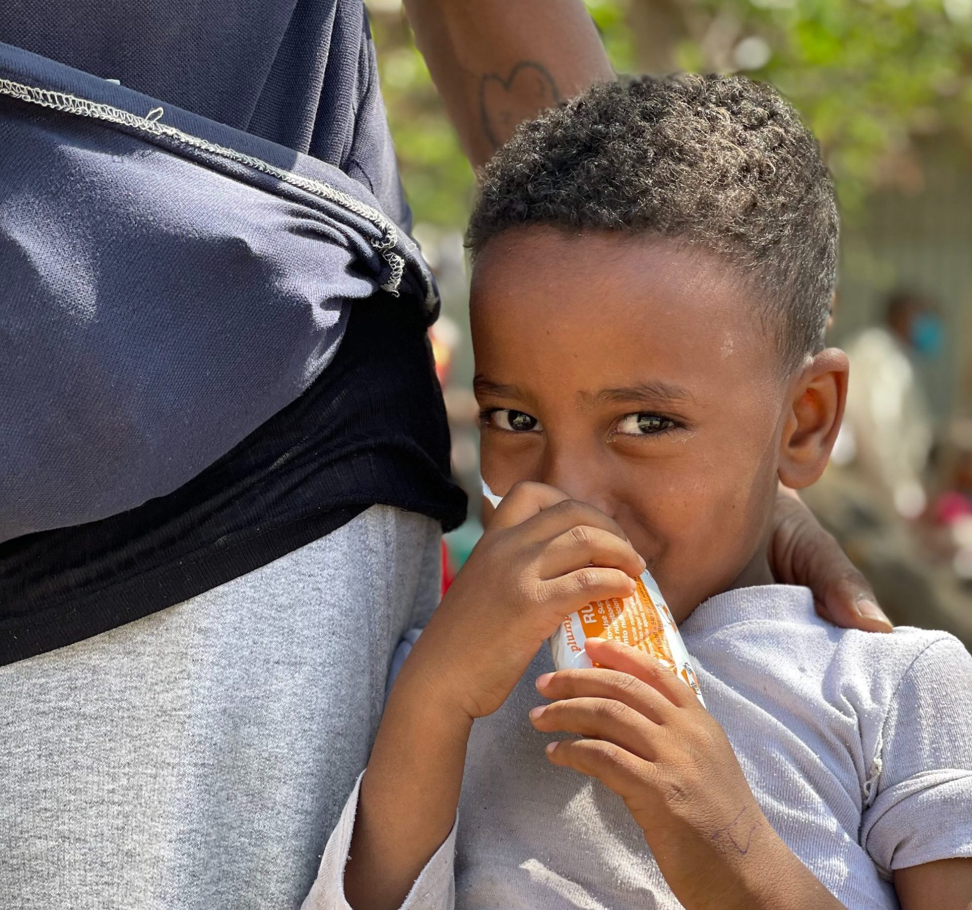 boy smiles while holding snack bar