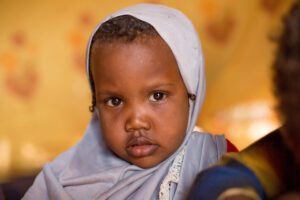young girl in blue headscarf