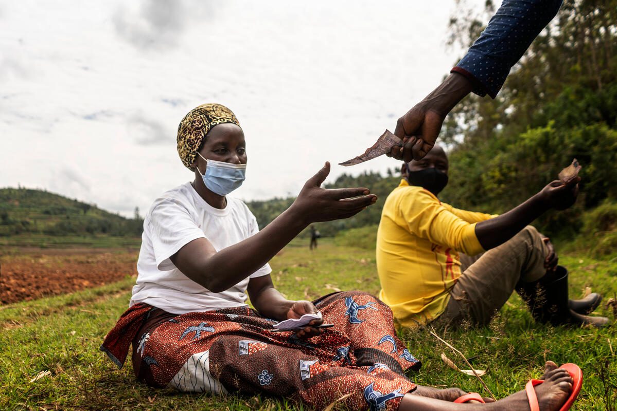 Immaculee takes part in her savings group in Nyaruguru district, Rwanda on 28th of May 2021.

Immaculée is part of a WFP-supported farmer&#039;s cooperative with over 300 members. She is also part of a savings group. Thanks to the training and support she&#039;s received through WFP&#039;s Farm to Market Alliance programme, Immaculee has expanded the quantity and quality of her crops. Today, Immaculée grows enough to sell to a range of buyers, including WFP. She has expanded her farming activities, bought cows and plans to continue exploring ways of enhancing her agricultural and livestock produce. Immaculée primarily grows iron-rich single variety beans, which she sells through the farmers’ cooperative. WFP buys beans from the cooperative for its home-grown school feeding programme in Rwanda and has become one of the cooperative’s main buyers. 

&quot;WFP not only trains us but comes back to buy our produce,&quot; says Immaculée. &quot;It feels good to know that your produce is reaching children in your very own community.&quot;

WFP continues a range of support programmes across Rwanda, including food assistance to refugees and returnees,, providing daily meals to school children and supporting schools to improve education outcomes, and achieving greater national and regional market access for smallholder farmers.