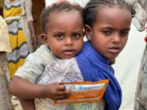 young boy and girl holding WFP rations