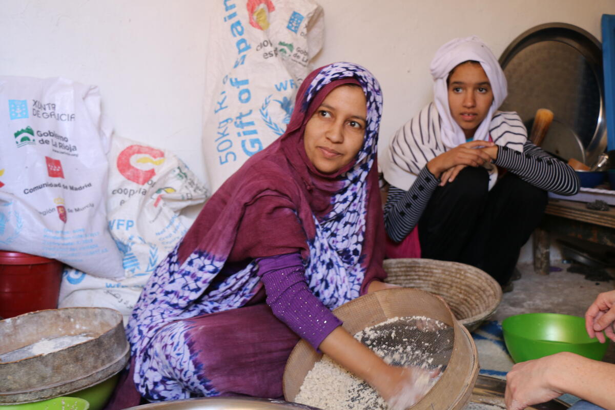 Algeria, Smara refugee camp. Tindouf, 27 November 2017.

Algeria has hosted refugees from Western Sahara since 1975 in what has become one of the worldÕs most protracted refugee crises. The Sahrawi refugees are located in five camps near the town of Tindouf in Western Algeria. The harsh and isolated desert environment limits opportunities for self-reliance and, as a result, the refugees depend on humanitarian assistance for their survival.

Malnutrition and anaemia rates had been high in the past, but recent assessments have shown an improvement of the overall nutrition situation of women and children. 

In the photo: Afaf prepares cuscus with barley and wheat flour from WFP food rations at Smara refugee camp.

Photo: WFP/Lourdes Melendo