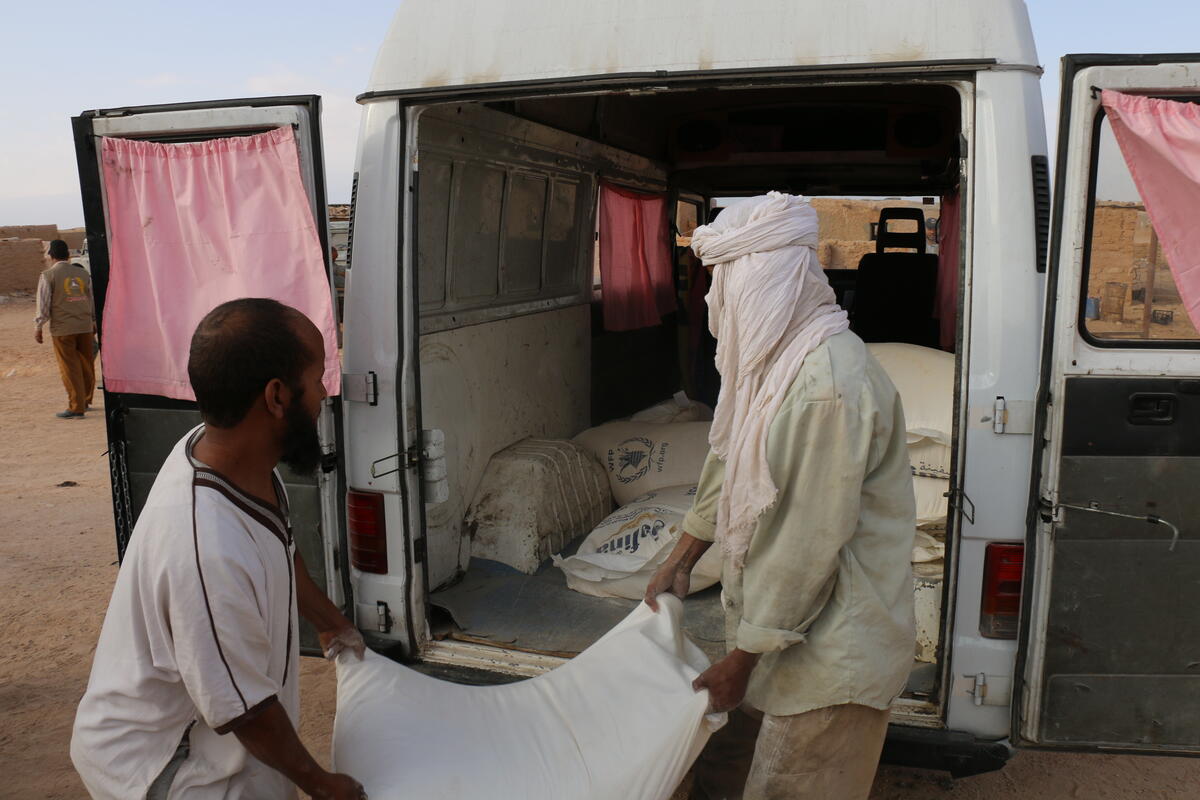 Algeria, Laayoune refugee camp, Tinduf, 29 November 2017

Algeria has hosted refugees from Western Sahara since 1975 in what has become one of the worldÕs most protracted refugee crises. The Sahrawi refugees are located in five camps near the town of Tindouf in Western Algeria. The harsh and isolated desert environment limits opportunities for self-reliance and, as a result, the refugees depend on humanitarian assistance for their survival.

Malnutrition and anaemia rates had been high in the past, but recent assessments have shown an improvement of the overall nutrition situation of women and children. Both chronic malnutrition and global acute malnutrition among children aged 5 or less are at an all-time low. However, anaemia rates, indicating a dietary iron deficiency, are alarmingly high- at 39 percent among children aged 5 or less, and 43 percent among women of reproductive age. The latest assessments also suggests the emergence, amongst the refugee population, of new issues of public health concern, namely overweight and obesity affecting mostly women, as well as diabetes.

In the photo: Food distribution at Laayoune refugee camp 

Photo: WFP/Lourdes Melendo