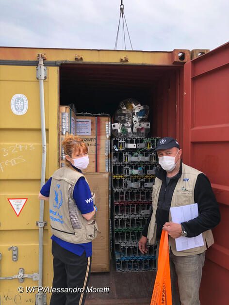 WFP staff load up mobile storage units.