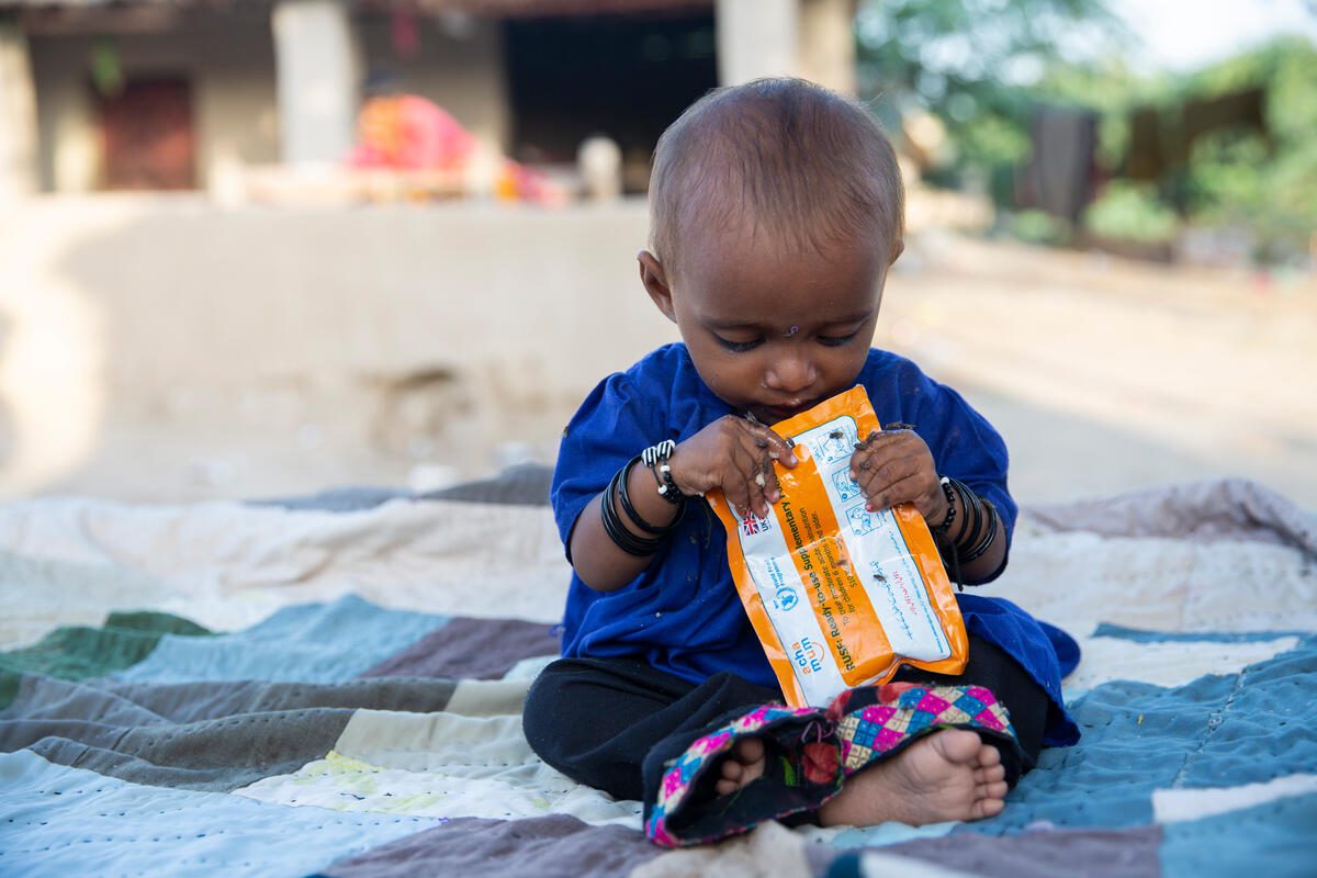 7-month-old Hariyan eating a nutritional pack provided by WFP