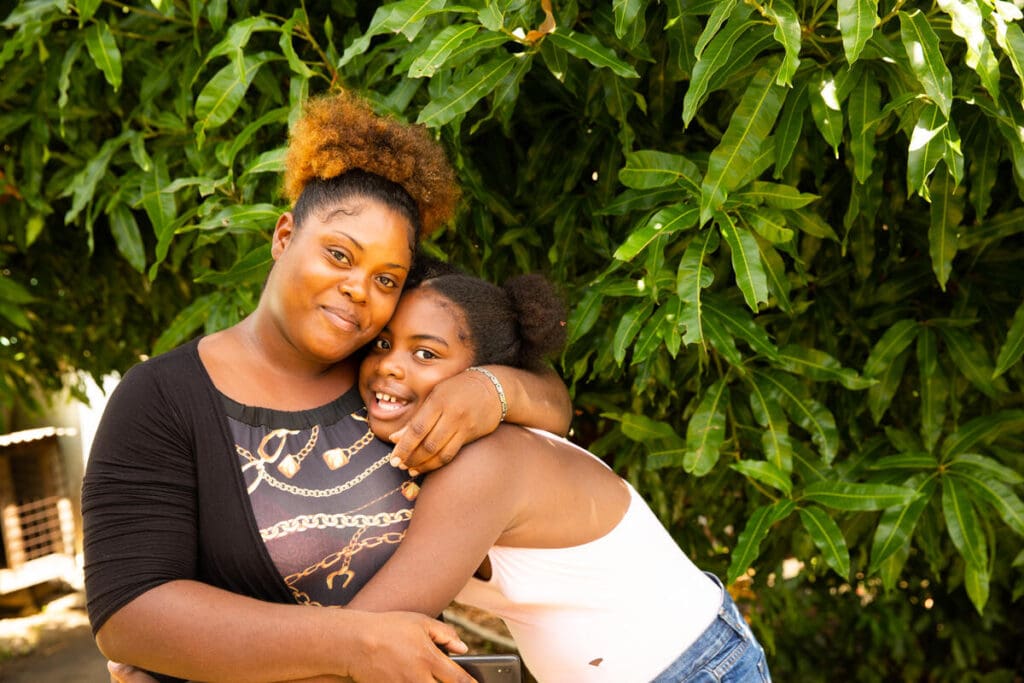 Tracy holding her daughter and smiling