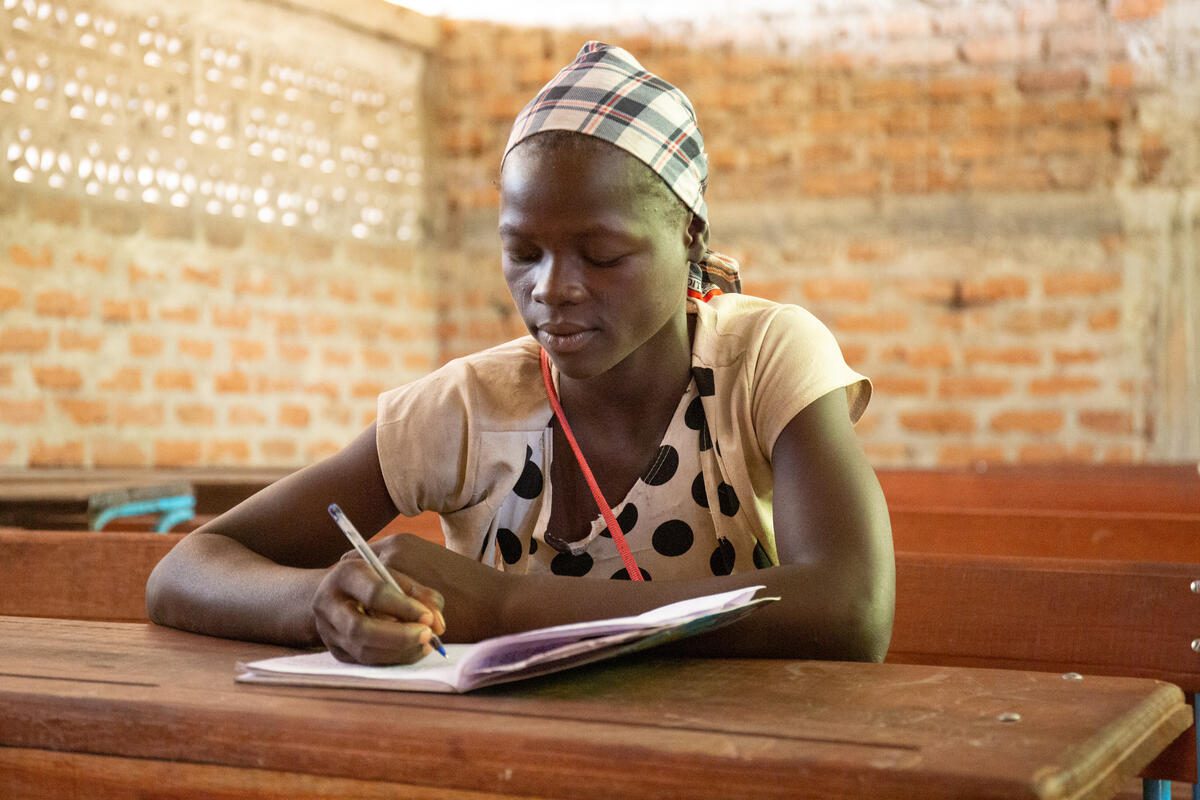 Mariam poses for a photograph in an empty classroom at her school in a refugee camp in Chad. A school feeding program is implemented at the school by WFP and its implementing partner SECADEV. Mariam has received a take-home ration of 10,000 CFA from WFP as a reward for 80% attendance in class, which she has used to buy books and clothes for school. It has also allowed the family to re-enroll her in school. Mariam says that she wants to become a teacher to help her sisters and brothers, and others in the refugee camp, like she was helped.

This refugee camp in Chad is home to over 9000 refugees. Before WFP’s intervention, the school counted 1273 students; following the implementation of the school meals the primary school now hosts 1704 students. WFP and its partners have provided support in the form of rice, legumes, oil and salt for school meals for all students, as well as take-home rations for girls with regular attendance and a scholarship of excellence for the top performing students. In addition, in 2021, WFP provided equipment and seeds for a community-run garden where parents of school children grow and harvest sorghum and groundnut to complement the school meals at the school. The community is now able to use seeds from this year&#039;s crop yield to sow for the coming season. WFP has also provided a local breeder with goats, which are either to be used for meat in school meals or sold to generate income for the school. 

In Chad, over 228 000 students across 569 schools benefit from daily nutritious meals. The school meals program in Chad prioritizes pre-adolescent and adolescent girls, which has had significant impact. The average pass rate for girls in WFP-assisted schools is 2.5x higher than the national average. However, the funding situation for the school meals program remains critical. WFP needs USD 10,6 million for 2023 to sustain operations and expand the coverage of home-grown school feeding in Chad.