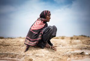 An old woman in a saline field in Yemen