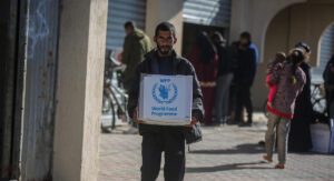 Man holds WFP box of food in Gaza