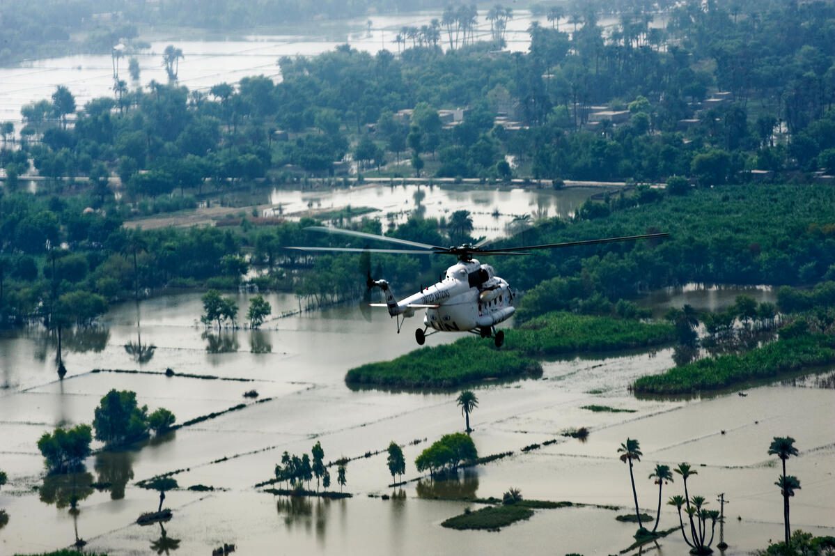 Helicopter flies over flooded land