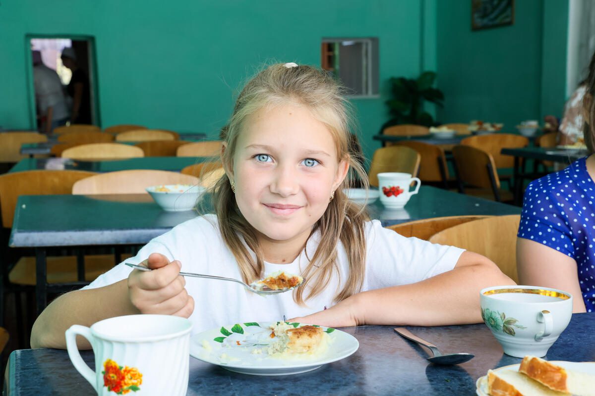 Student eating school meal in Ukraine