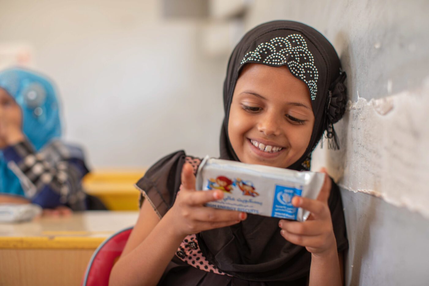 a young girl holding an energy bar