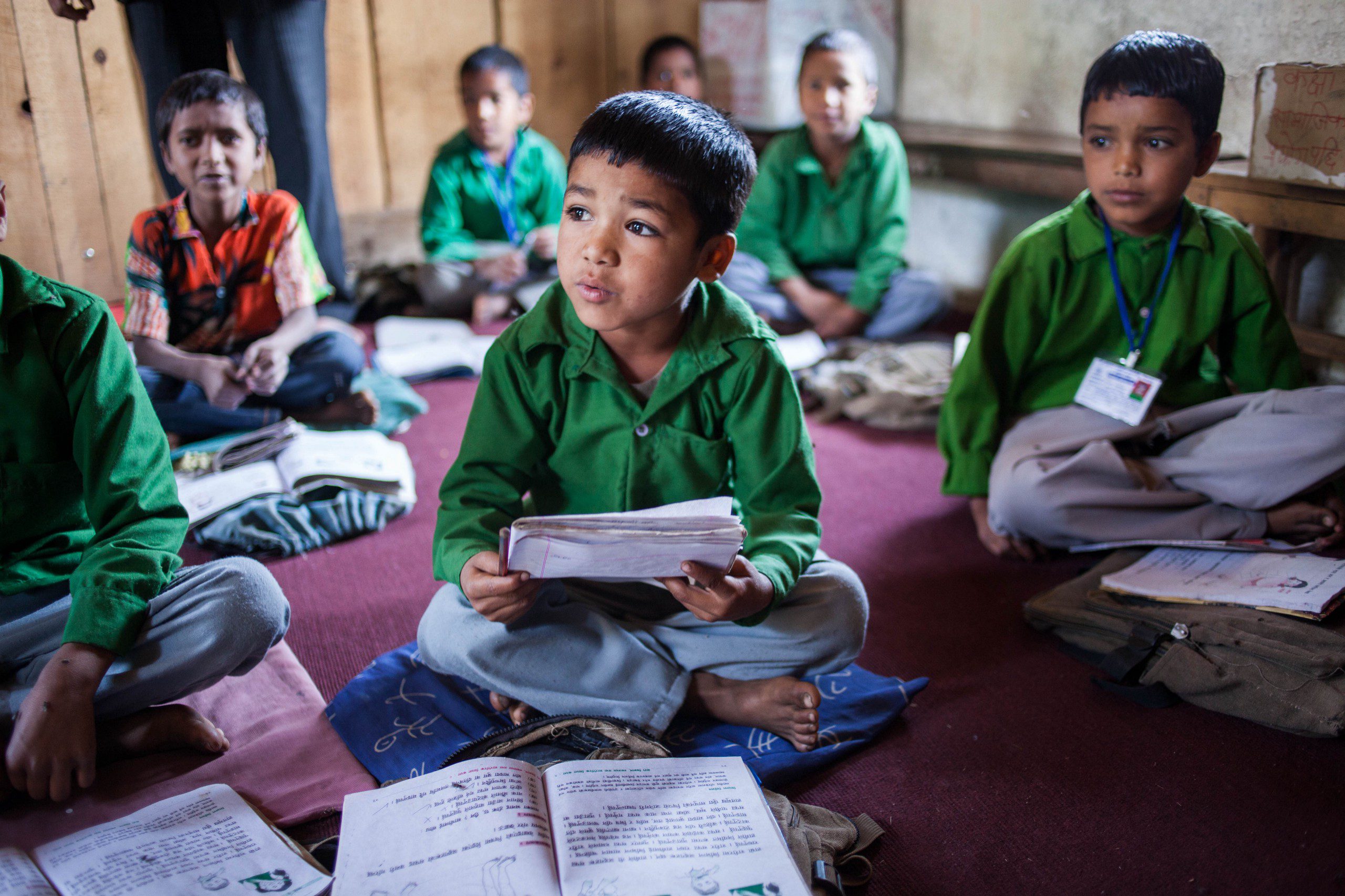 Students in a Nepalese primary school study reading.