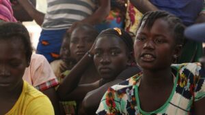A group of women sit together in an IDP camp