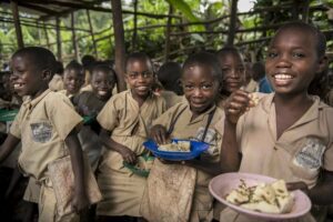 schoolchildren in brown uniforms eating