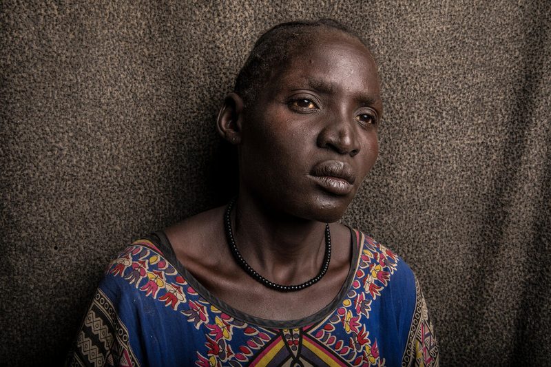 woman in blue and orange shirt alone