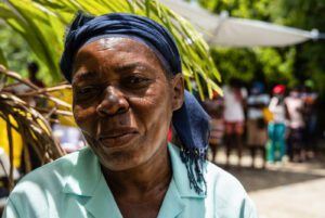 woman in green shirt and blue headband