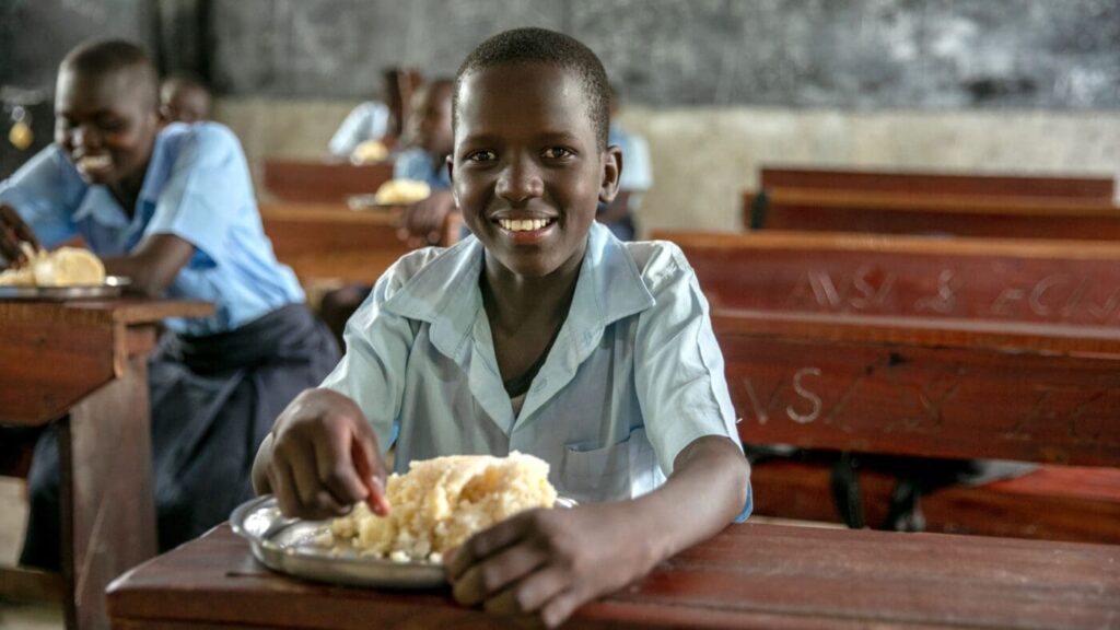 Andrew Lodikio eating lunch in South Sudan