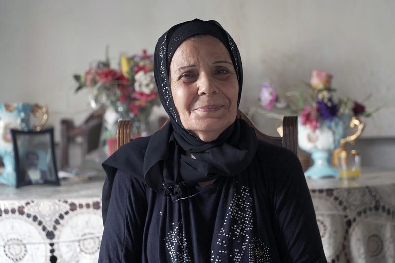 older woman in black headscarf and dress