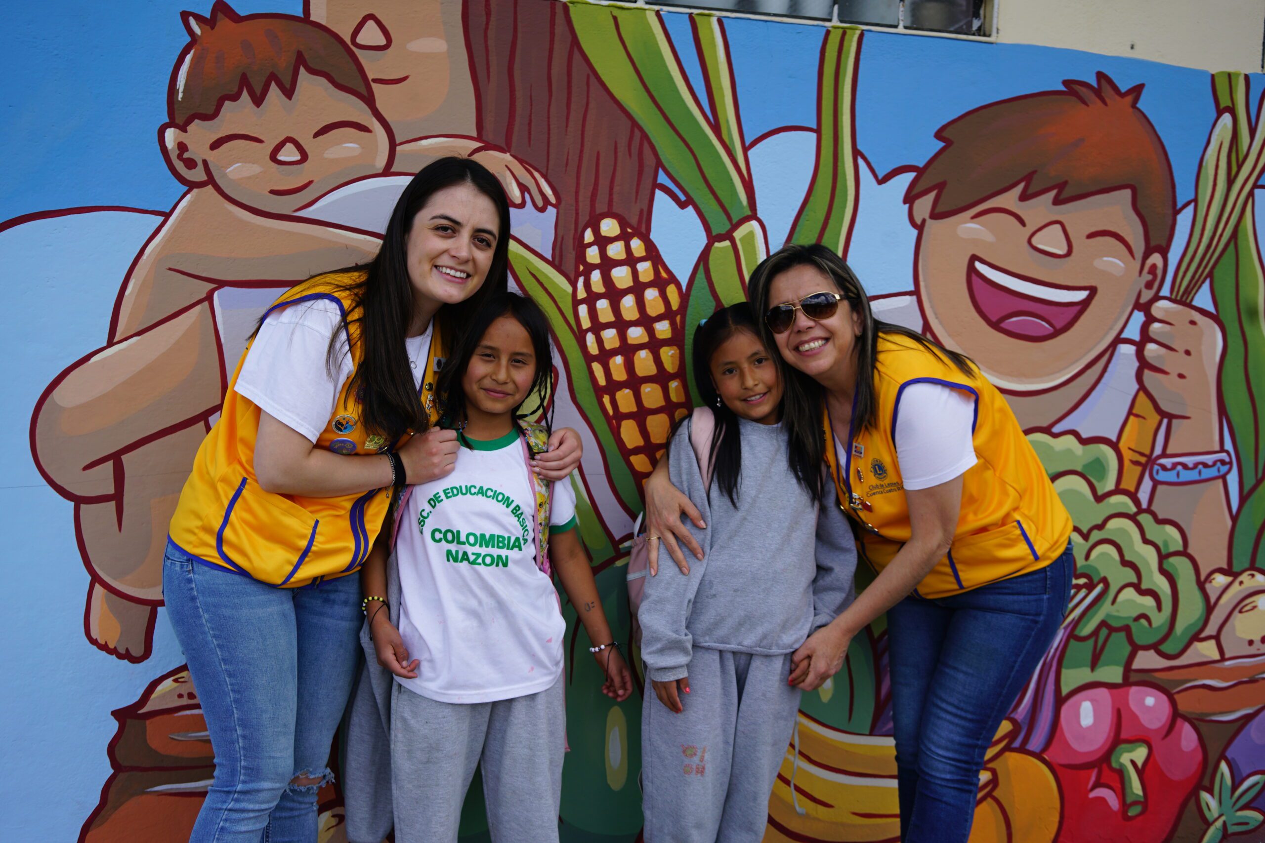 People standing in front of mural