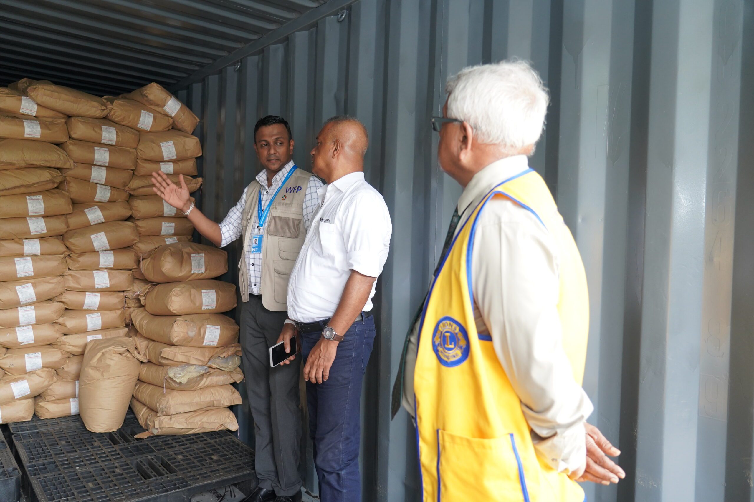 WFP staff look at rice fortification