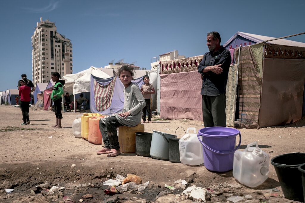 Displaced families wait for water in Gaza