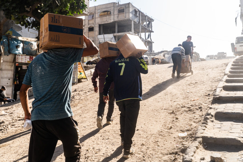 People receive food packages from WFP distribution point